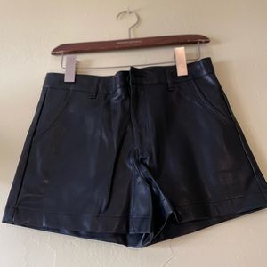 Design by Korea, approx 28” NWOT black synthetic leather short w/ front pockets.